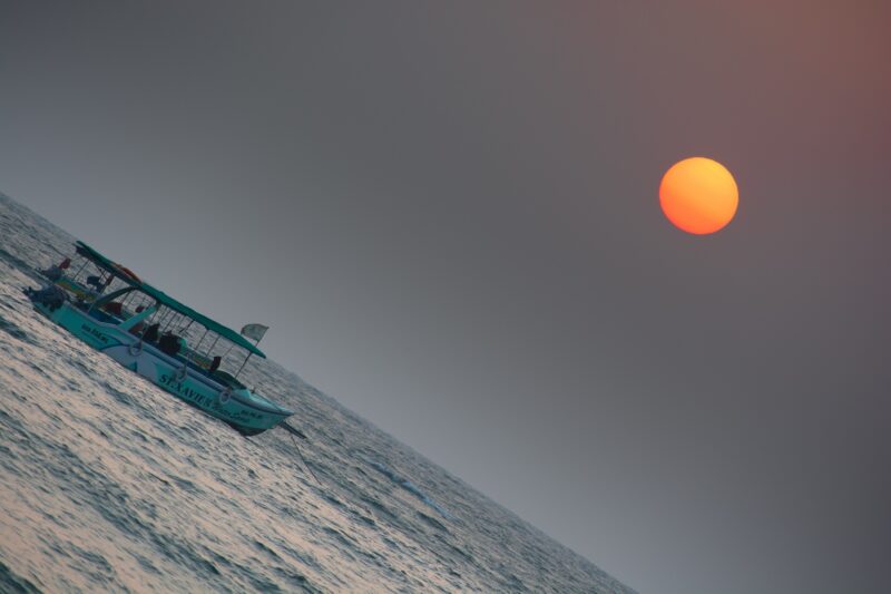 Baga beach sunset with boat in foreground